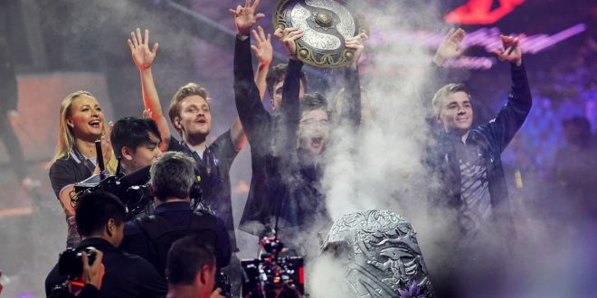 Sebastien "Ceb" Debs (C) of team OG holds the winner's trophy as the team wins the Dota 2 eSports Best of 5 final match during the International Dota 2 Championships in Shanghai on August 25, 2019. (Photo by STR / AFP) / China OUT        (Photo credit should read STR/AFP/Getty Images)